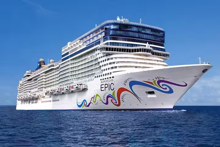 Norwegian Epic cruise ship sailing on blue ocean waters with colorful swirl artwork on hull