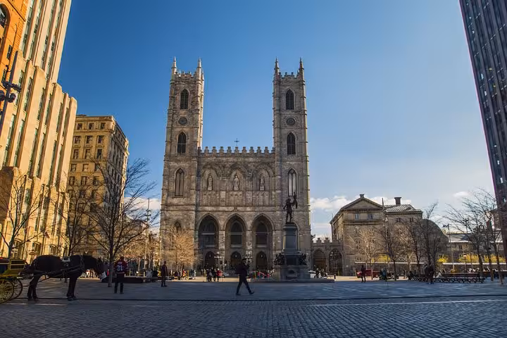Notre-Dame Basilica facade with twin towers on Place d'Armes square in Montreal