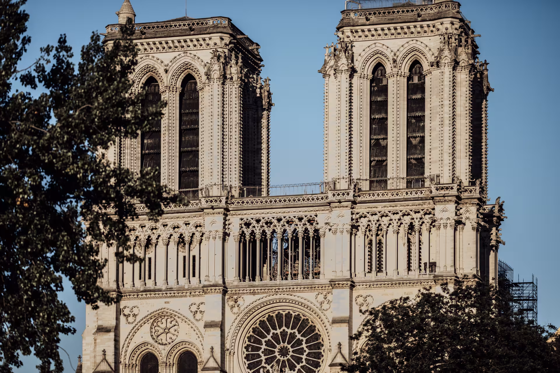 Notre-Dame Cathedral west facade with twin towers and rose window, Paris, under restoration scaffolding