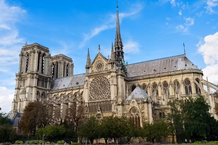 Side view of Notre-Dame Cathedral in Paris on a private half-day city tour, Seine cruise, and Louvre Museum entrance