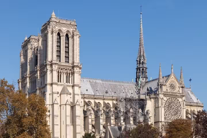 Notre-Dame Cathedral Paris with Gothic towers and spire under clear blue sky