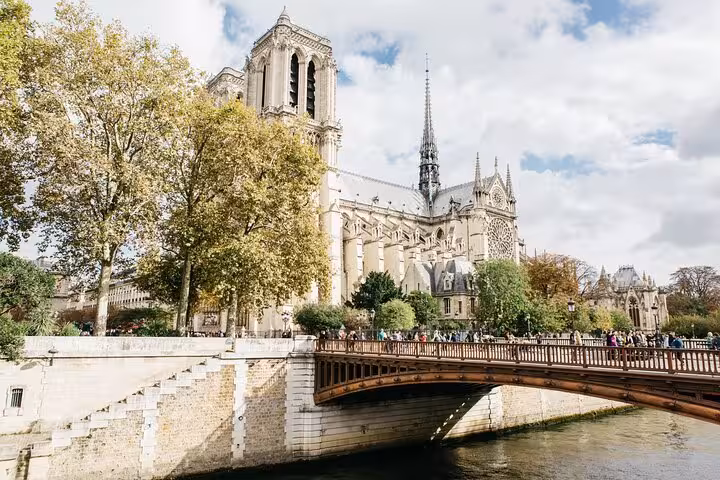 Notre-Dame Cathedral and Seine River bridge view, Paris landmark featured on a private historical walking tour