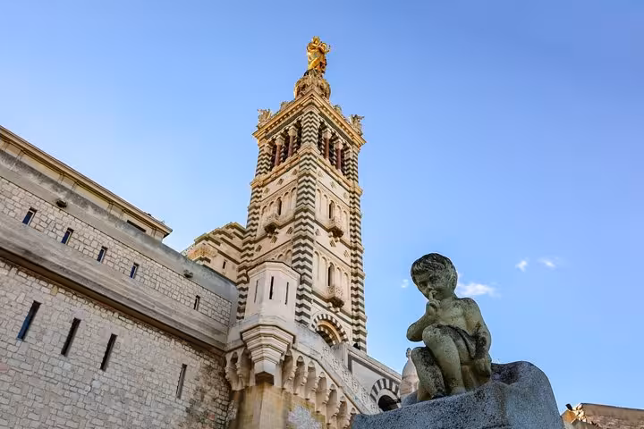 Notre-Dame de la Garde basilica tower with gold statue and cherub sculpture, Marseille
