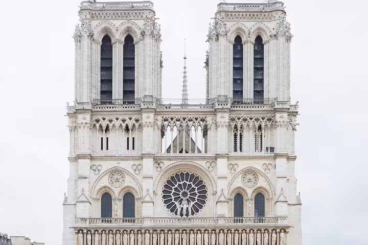 Iconic Gothic facade of Notre Dame Cathedral Paris featuring twin towers and rose window on kids guided tour