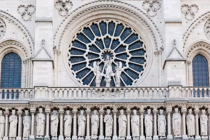 Close-up of Notre-Dame Cathedral rose window and statues on a private guided historical tour in Paris