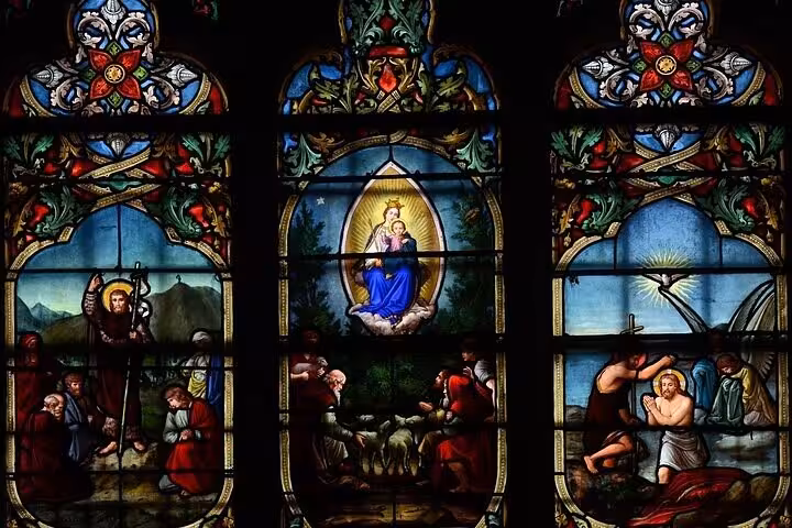 Stunning stained glass windows depicting Virgin Mary and saints inside Notre Dame Cathedral Paris tour