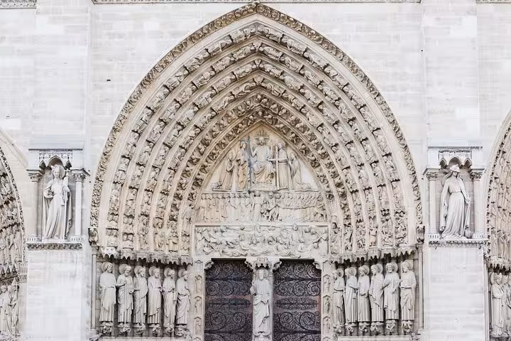 Close-up of Notre Dame west portal carvings and statues, featured on a 90-minute semi-private exterior tour