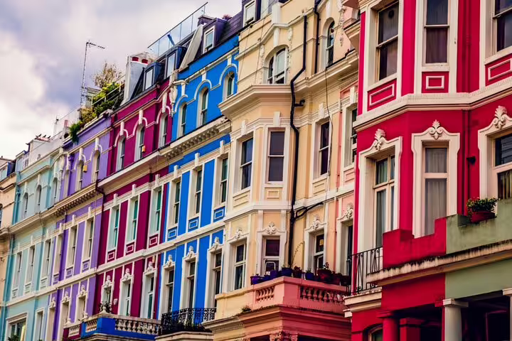 Colorful Victorian terraced houses with ornate facades on Notting Hill street, London