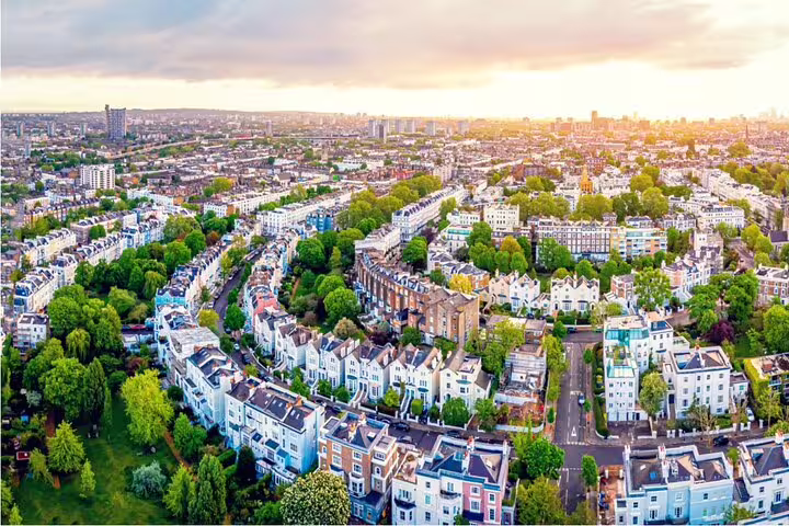 Aerial view of Notting Hill London colorful townhouses tree-lined streets at golden hour