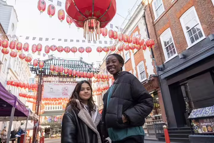 Visitors enjoy vibrant lanterns and historic architecture in London's Notting Hill during a private highlights and markets tour.