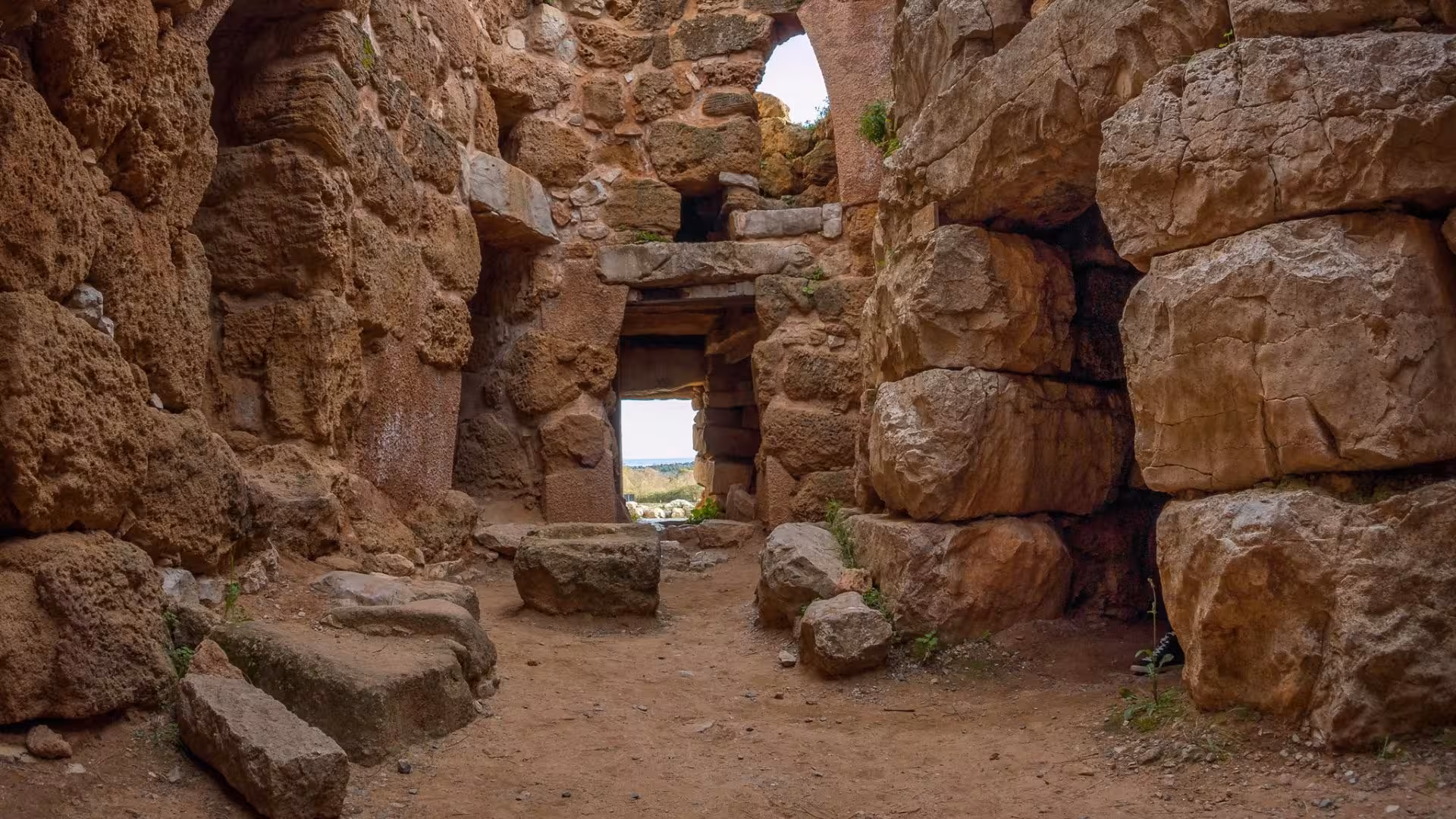 Explore the ancient stone corridors of Nuraghe Palmavera on a guided tour in Porto Conte Park near Alghero.