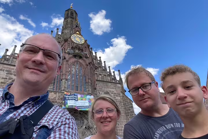 Family selfie at Nuremberg Frauenkirche clock, perfect stop on a self-guided scavenger hunt tour