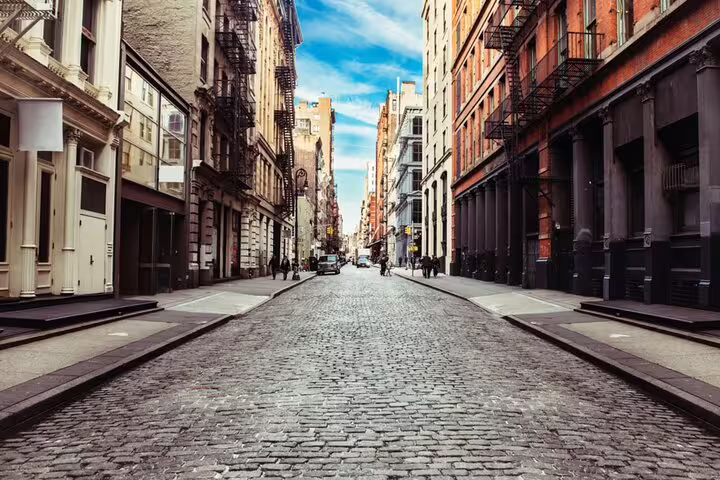 Cobblestone street lined with historic brick buildings in SoHo, New York City