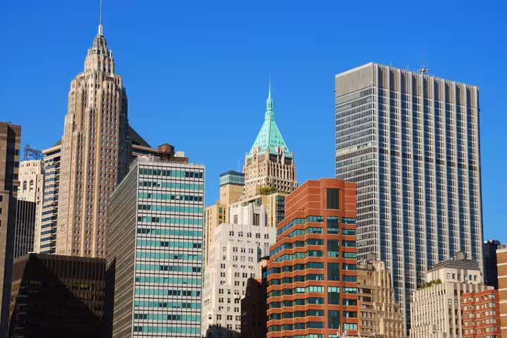 Lower Manhattan NYC skyline with Art Deco skyscrapers and blue sky