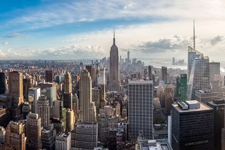 Aerial view of Manhattan skyline with Empire State Building and NYC skyscrapers on a sunny day