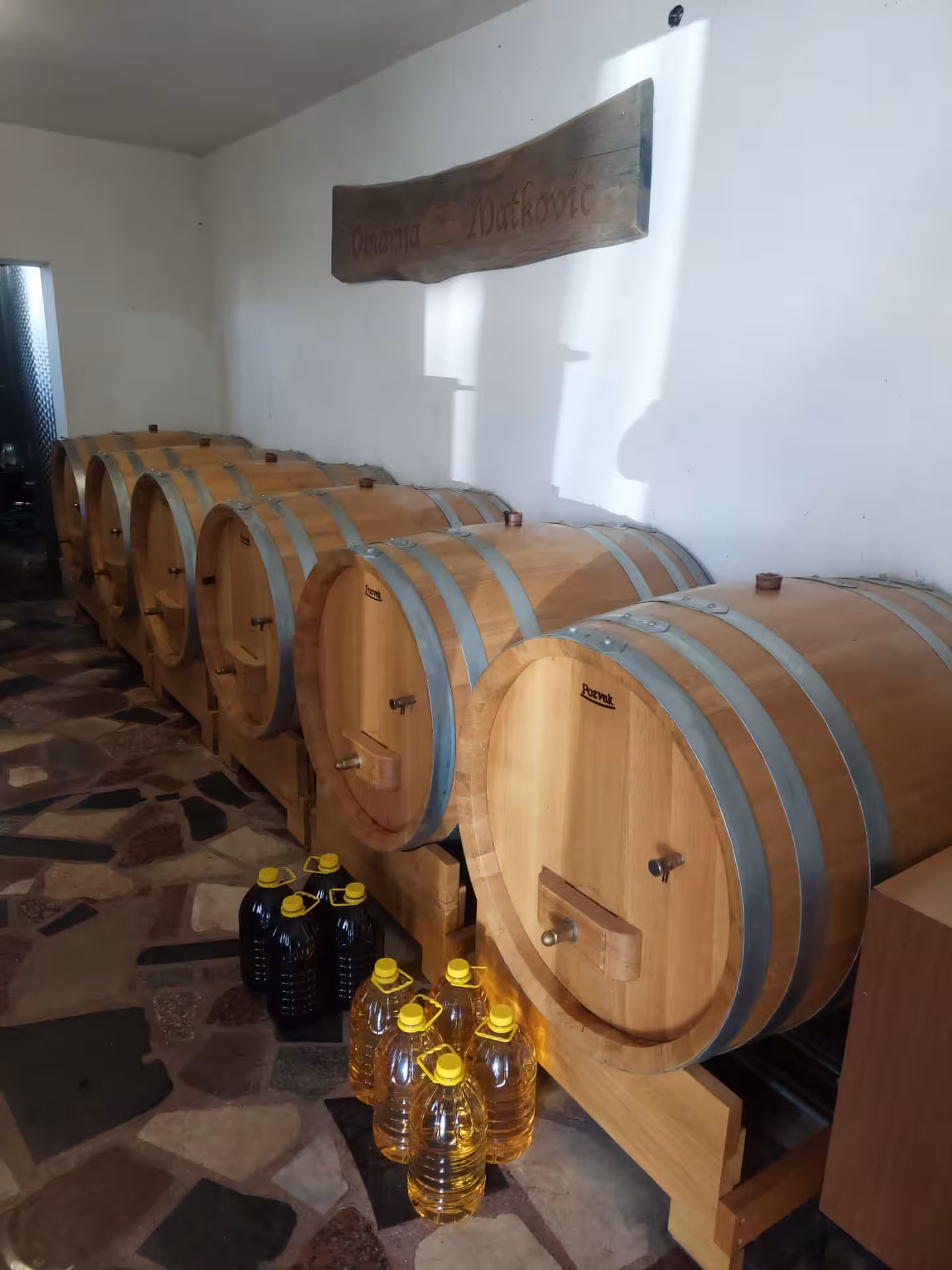 Oak wine barrels in a Dalmatian cellar, tasting stop on Split hidden gems tour to Imotski Lakes