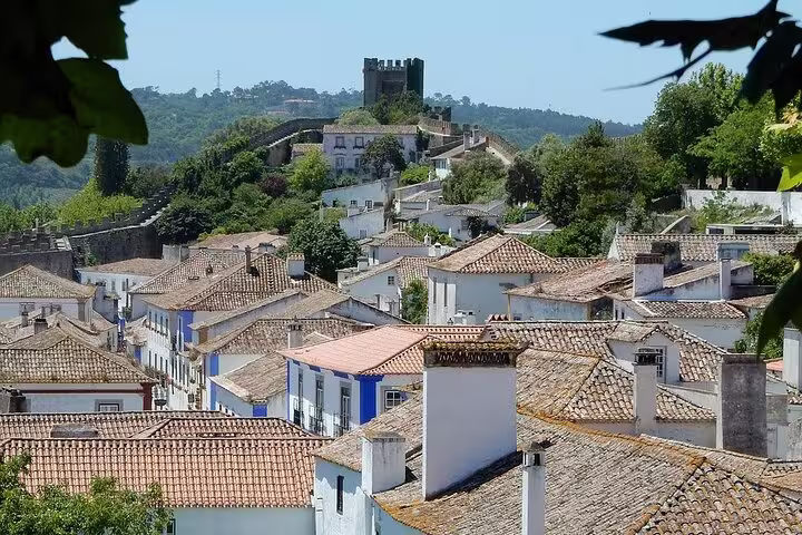 Charming medieval town of Óbidos with its iconic castle and tiled rooftops, ideal for a Lisbon to Porto transfer stop.