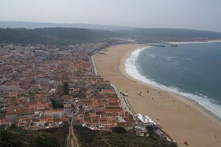 Aerial view of the picturesque coastal town and sandy beaches near Óbidos, Portugal, featured in the Fátima and Óbidos small group tour.