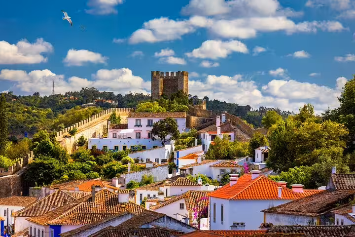 Scenic Óbidos village with medieval castle walls and red-tiled roofs, stop on private Lisbon day tour to Fátima and Nazaré