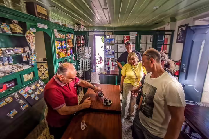 Visitors enjoy a local shop experience during the Óbidos, Nazaré, Alcobaça, Batalha, and Fátima full-day private tour from Lisbon.