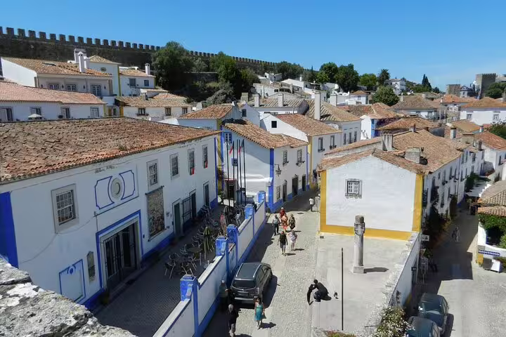 Charming view of Óbidos village with whitewashed houses and medieval walls on a small group day tour from Lisbon to Fátima, Nazaré, and Óbidos.