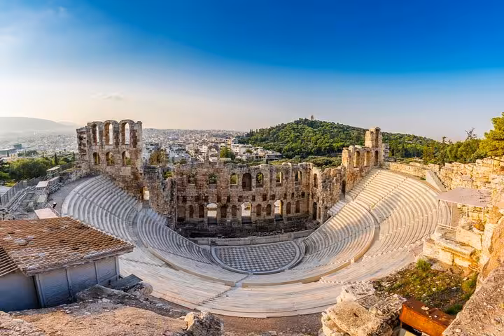 Odeon of Herodes Atticus ancient theater on Athens Acropolis with city skyline in background