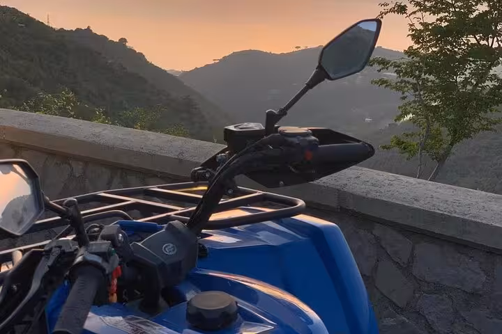 ATV parked with a scenic sunset view over the mountains on Mount Faito near Sorrento.
