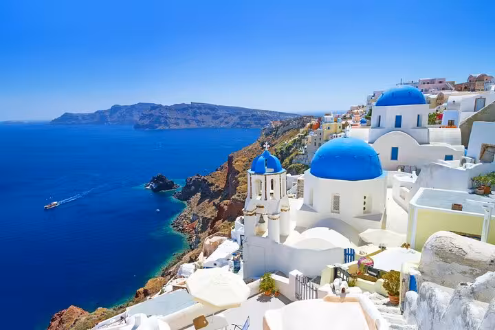 Oia blue-domed churches overlooking the Santorini caldera, a highlight of the Explore Santorini 5-senses tour