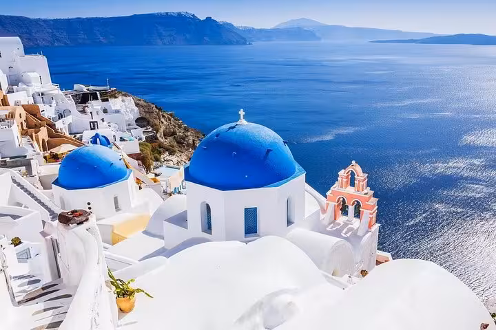 Oia blue-domed churches and Santorini caldera panorama on private tour from Athens with sightseeing and wine tasting