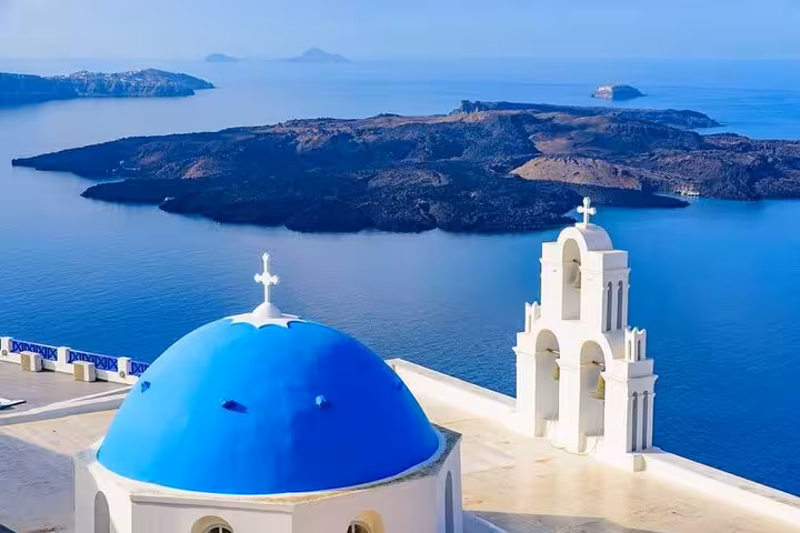 Oia Santorini blue dome and white bell tower with caldera sea view on 5-day private Mykonos & Santorini tour