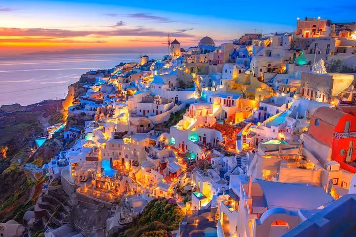 Oia Santorini sunset village lights over caldera, small-group island tour for cruise ship passengers