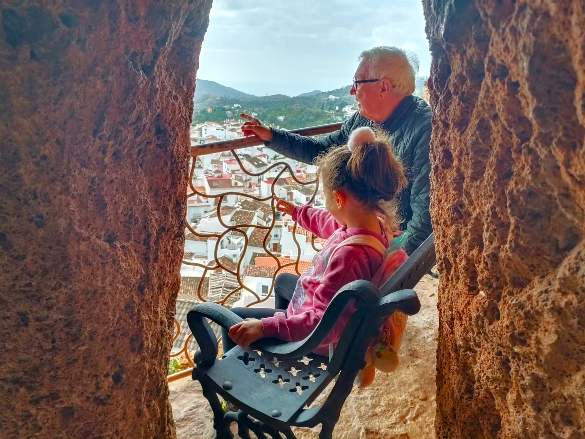 Family enjoying panoramic views over whitewashed Ojen village from a lookout on a private tour from Costa del Sol