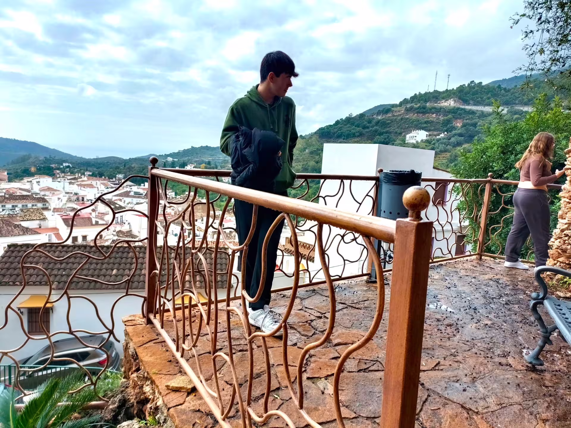 Travelers at Ojen viewpoint overlooking the white village and mountains during a guided private walking tour