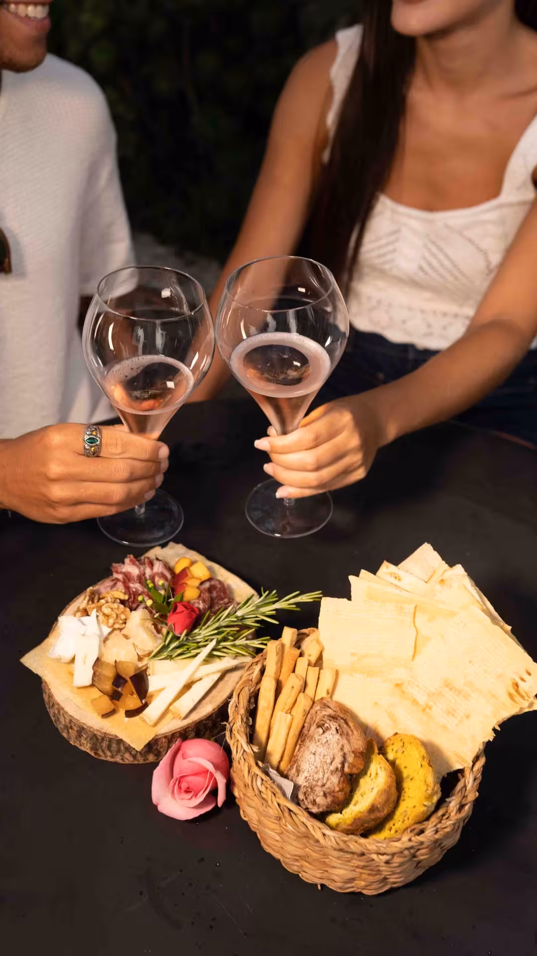 Couple enjoying aperitif with charcuterie and wine in Gallura winery, highlighting Olbia's culinary delights.