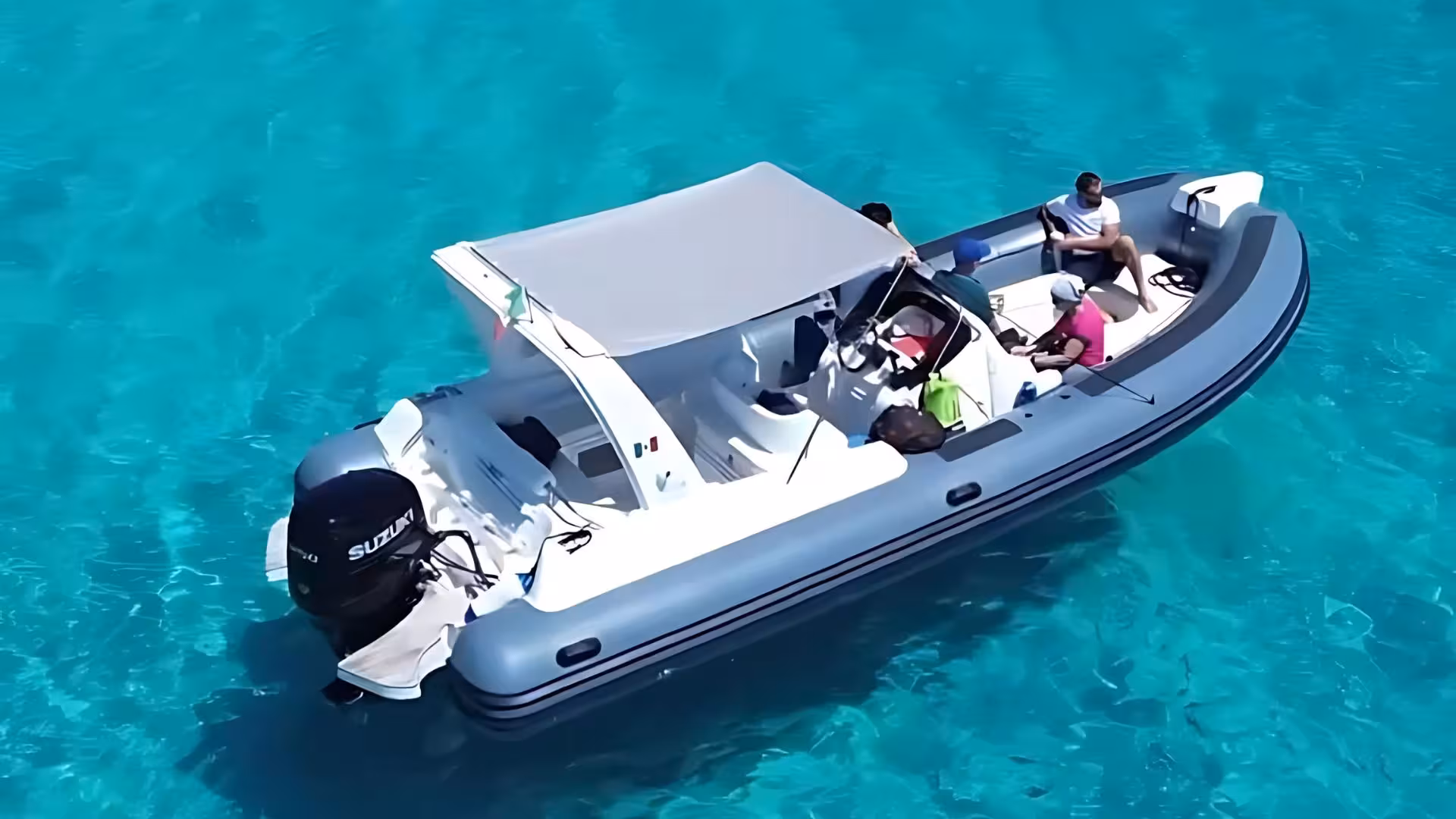 Group enjoying a dinghy ride over the turquoise waters near Tavolara, a highlight of Olbia snorkeling tours.