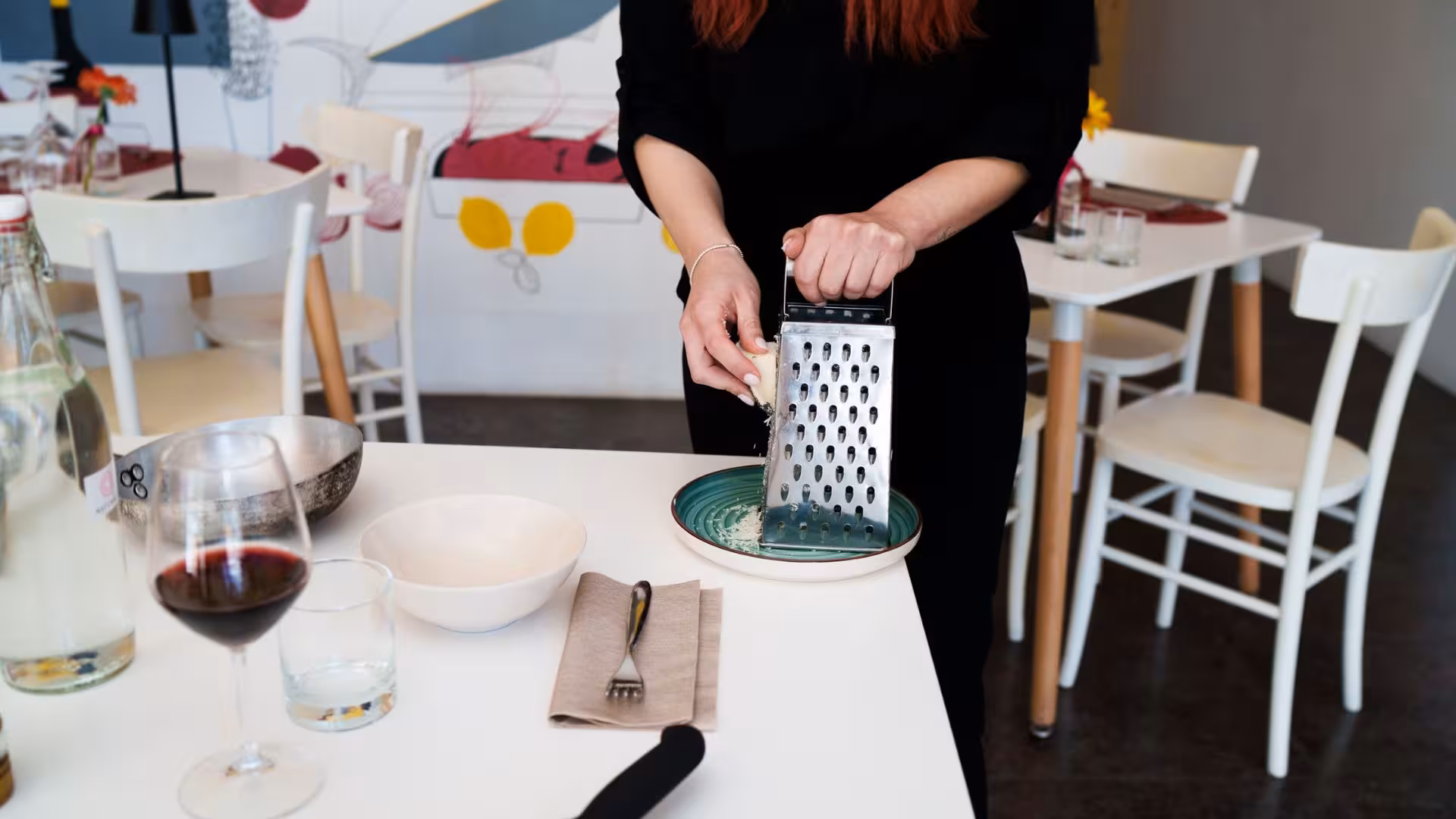 Cheese grating for pasta carbonara in a vibrant Olbia cooking class, capturing authentic Italian culinary techniques.
