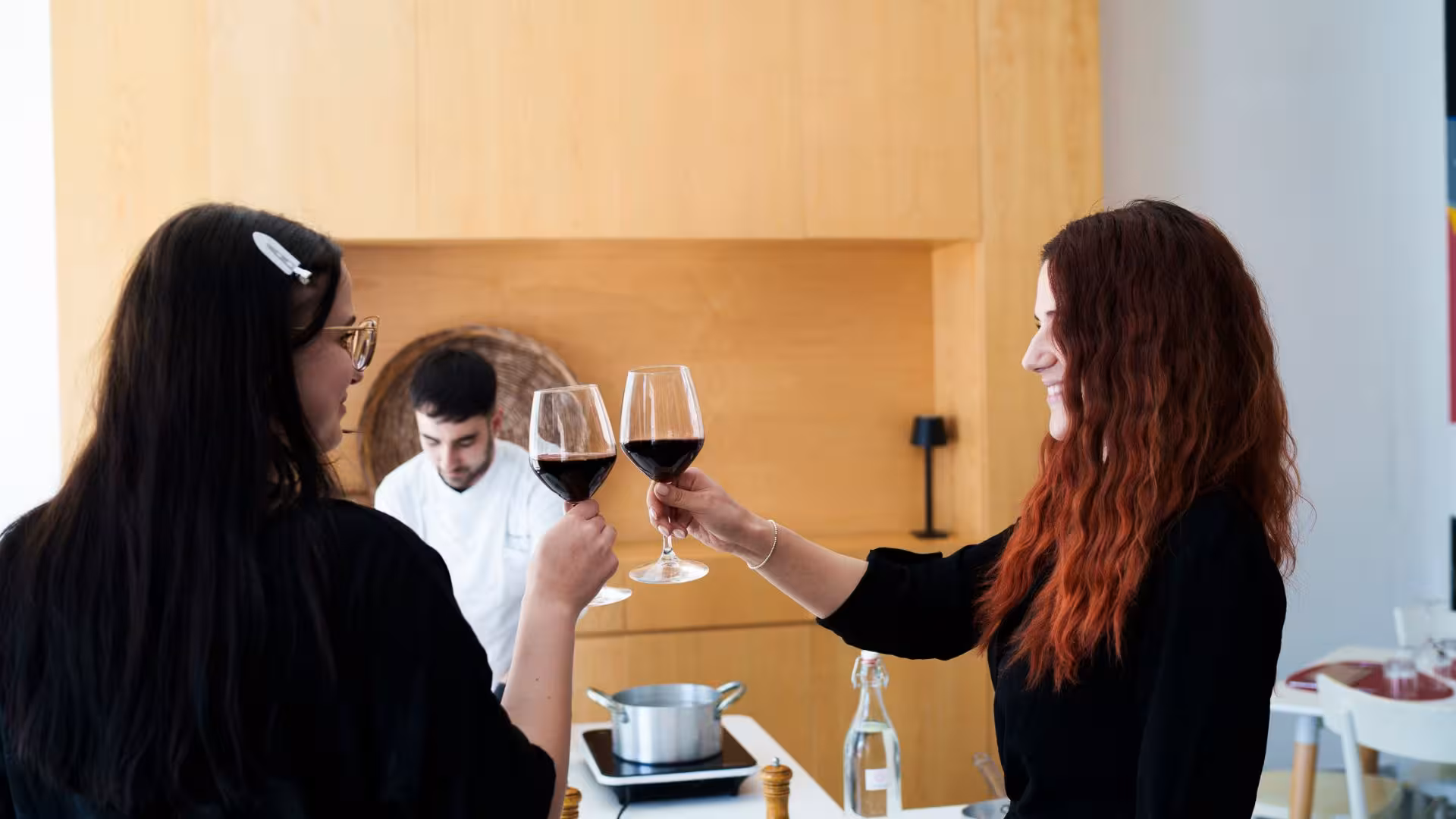 Participants enjoying wine during Olbia pasta carbonara cooking class.