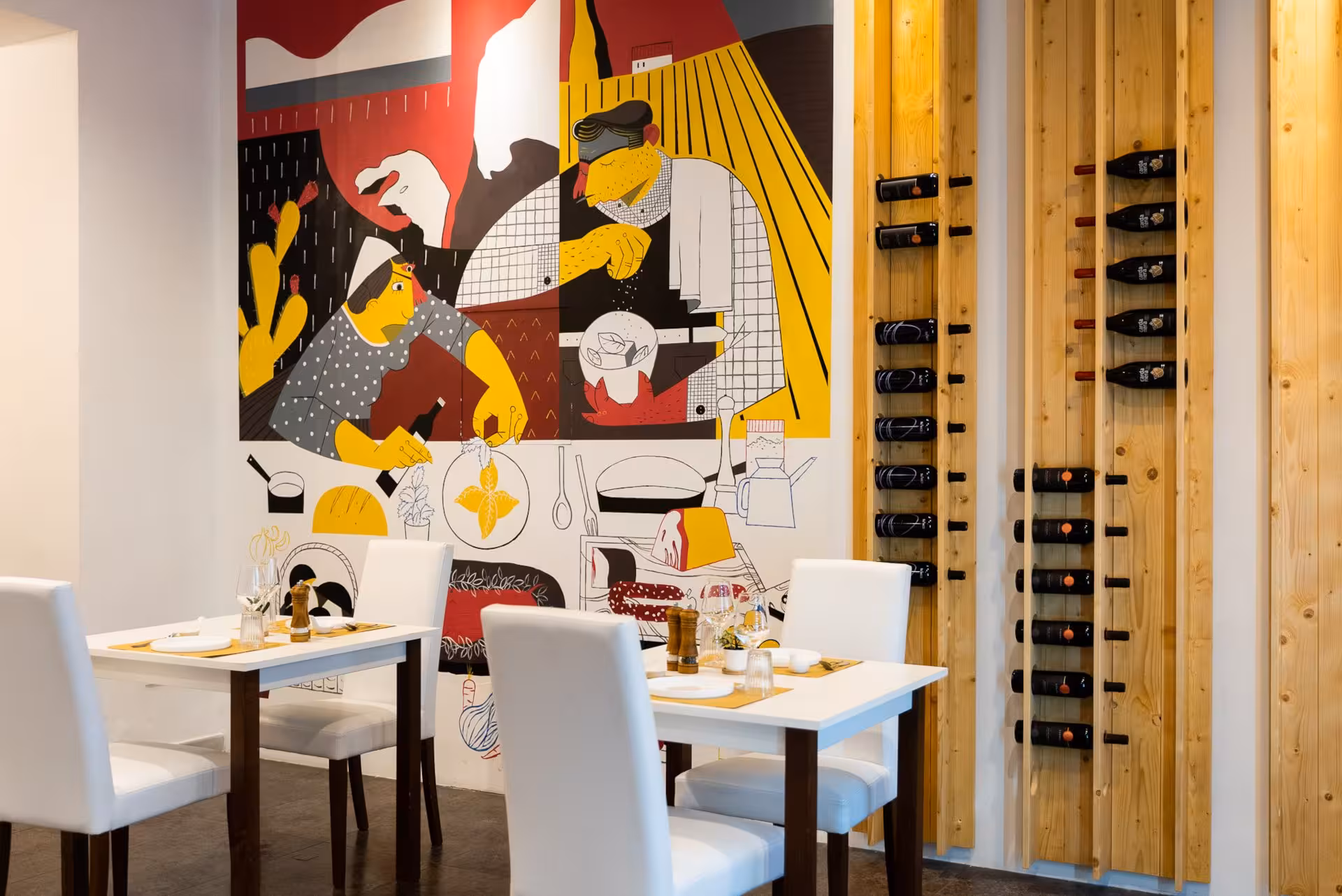 Cozy restaurant interior in Olbia featuring colorful wall art and wine rack, setting the stage for a pasta workshop.