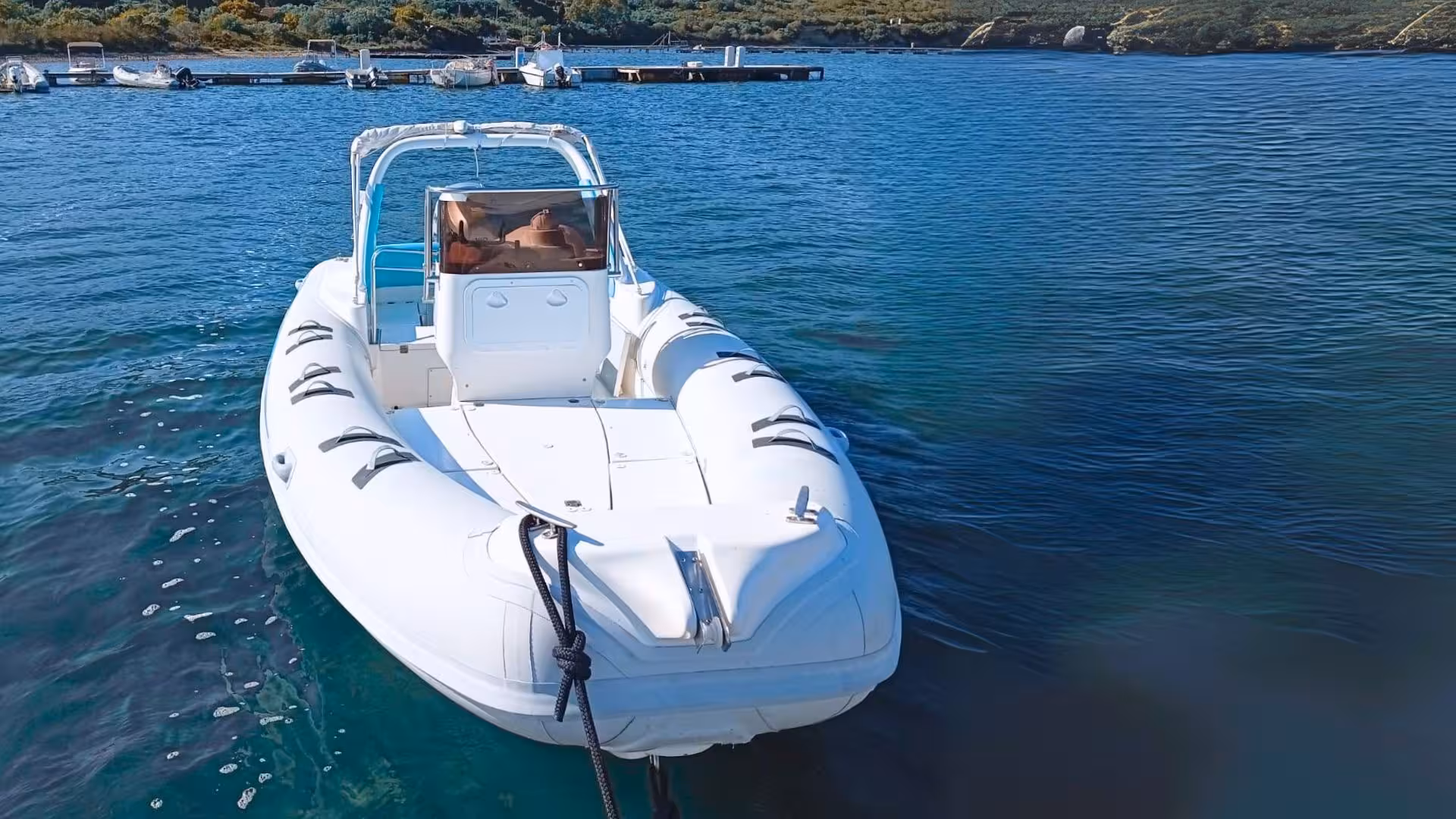 RIB boat docked at Cugnana, ready for an Olbia adventure exploring Capriccioli and Spiaggia del Principe's scenic beauty.