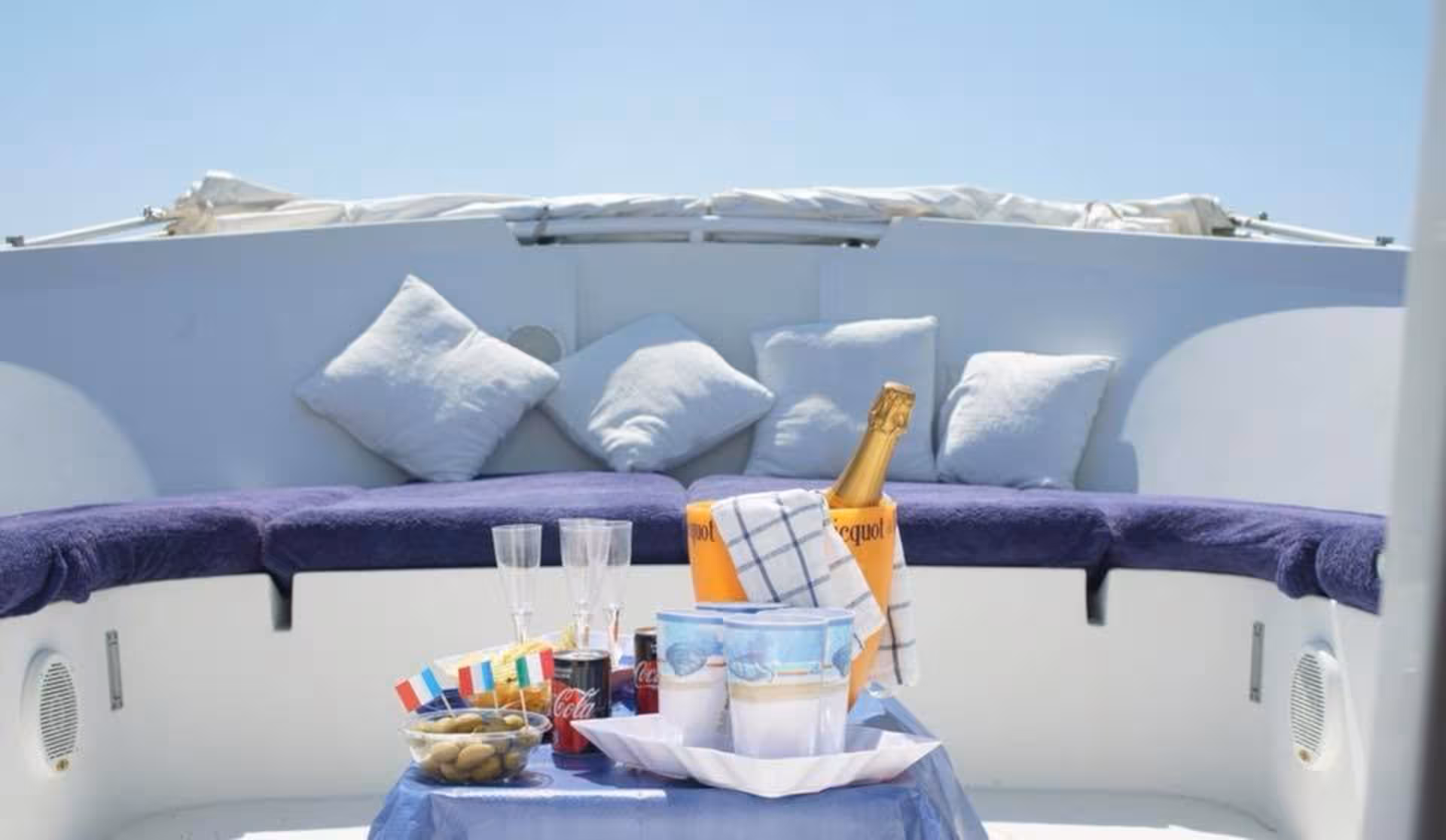 Luxurious seating area with champagne on a boat tour to Tavolara from Porto San Paolo.