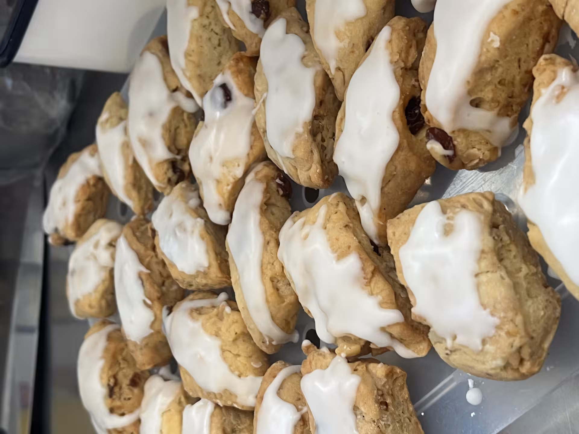 Freshly baked scones with icing, a delightful treat available during the Olbia wool supply chain tour.