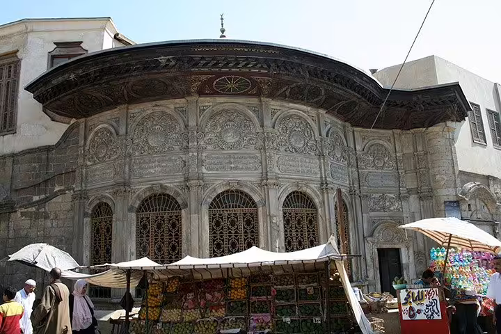 Old Cairo street scene with Sabil-Kuttab architecture and bazaar stalls, featured on a private Citadel tour Cairo