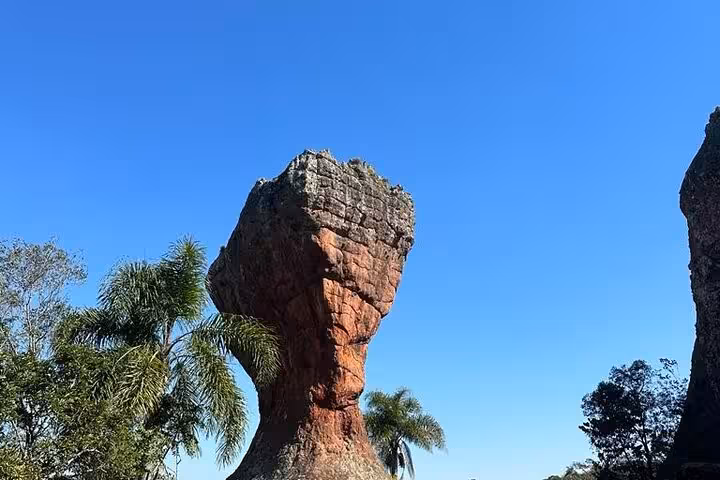 Marvel at the unique rock formations set against a clear blue sky at Old Town State Park, featuring lush surrounding vegetation.