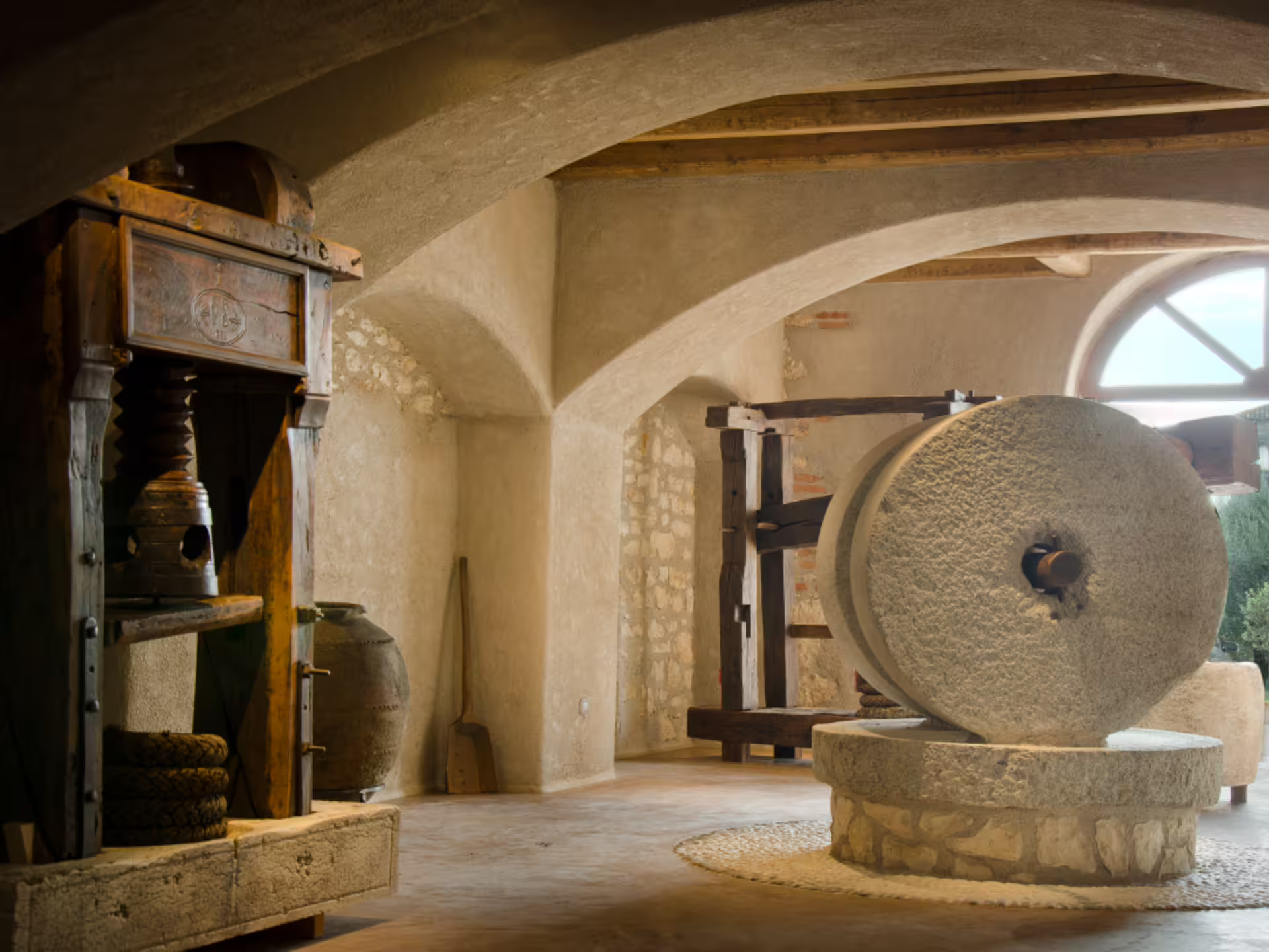 Historic olive mill stone press interior on Verona countryside tour with extra virgin olive oil tasting