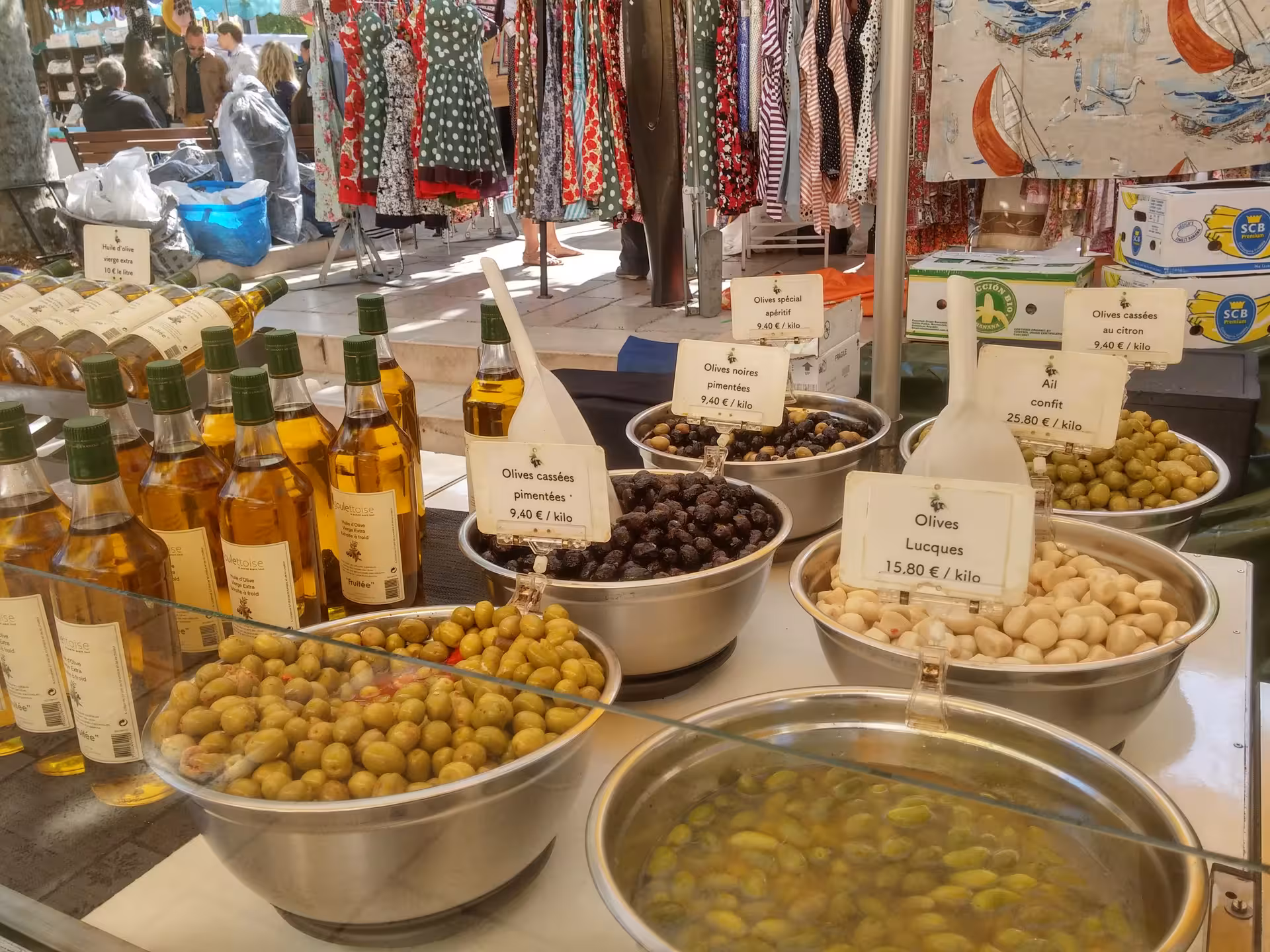 Olive tasting stand in Aix-en-Provence market with Provençal olives, olive oil bottles and local flavors