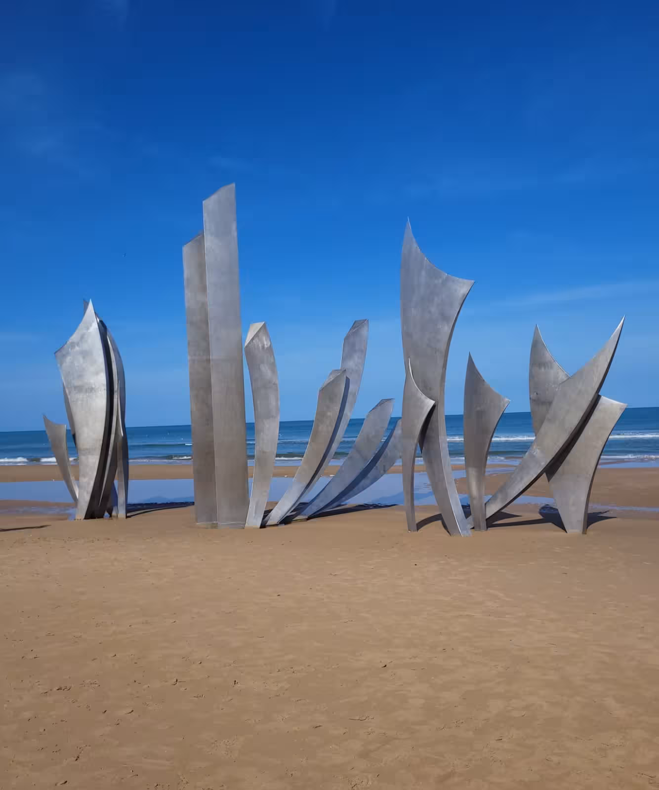 Omaha Beach Les Braves memorial sculpture on Normandy coast, stop on private guided D-Day tour from Deauville