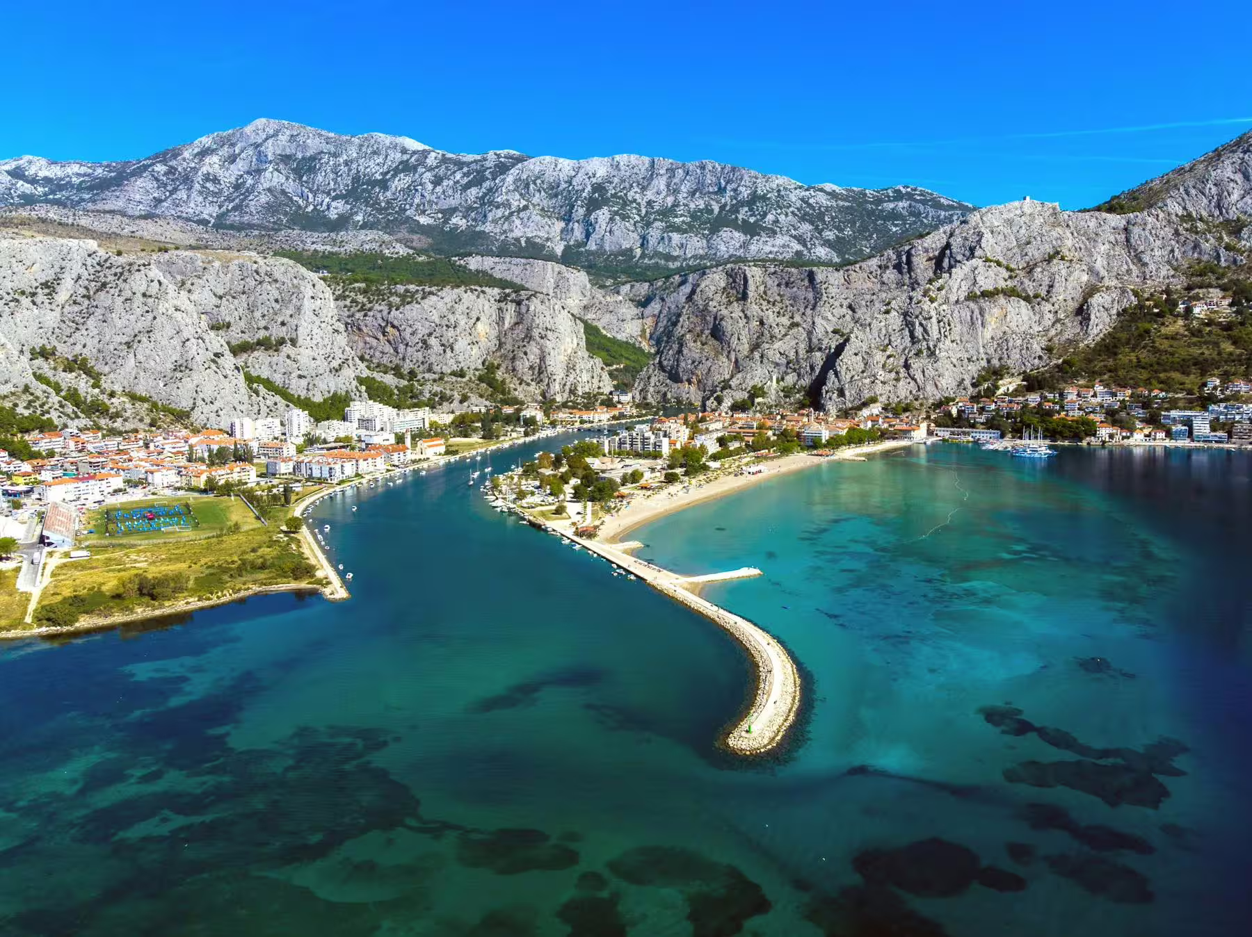 Aerial view of Omiš and Cetina River mouth on Adriatic coast, highlight of boat tour from Makarska Riviera
