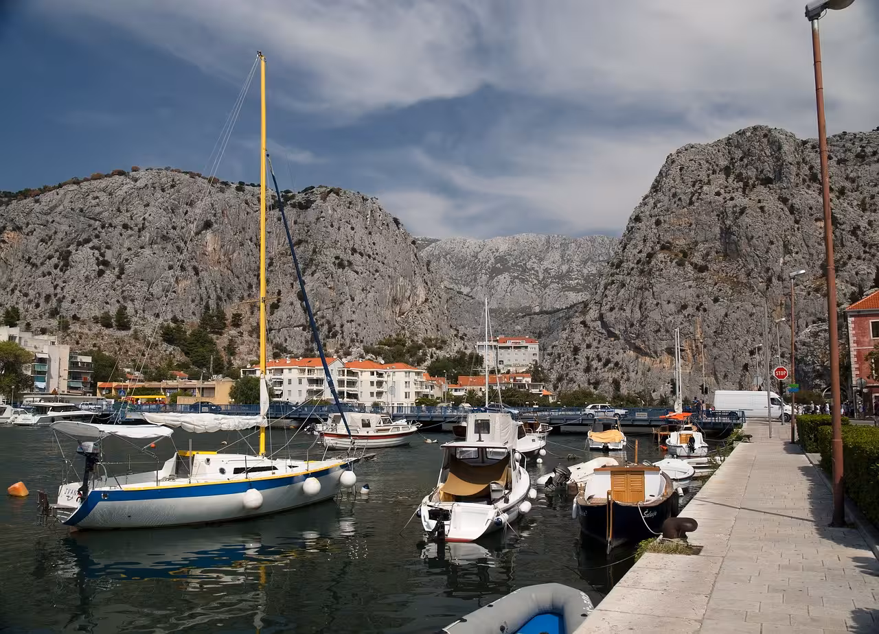 Omiš harbor with sailboats under dramatic cliffs, scenic stop on Pirates of Omiš & Garage wine tasting tour