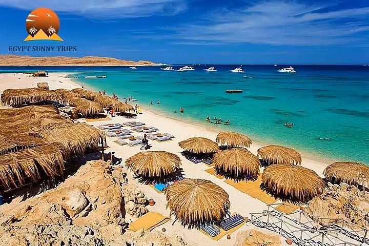 Orange Bay Gifton Island beach with straw huts and turquoise Red Sea, Hurghada snorkeling tour boat stop