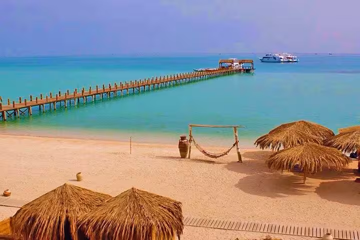 Orange Bay Giftun Island beach with long pier and turquoise water on Hurghada snorkeling tour, Red Sea